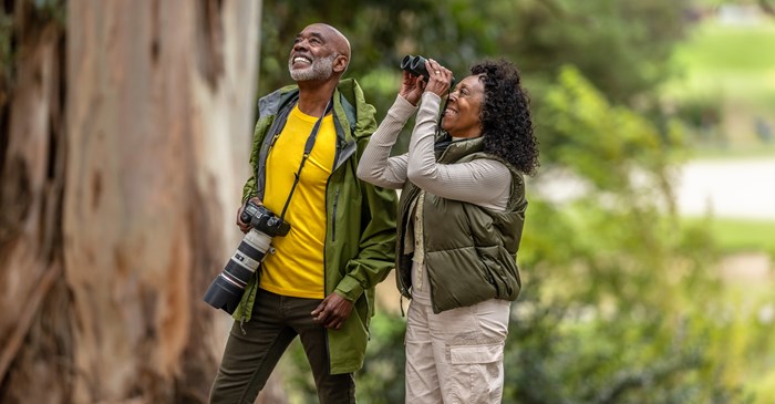 Bird watchers in woods / Getty Plus / JasonDoiy