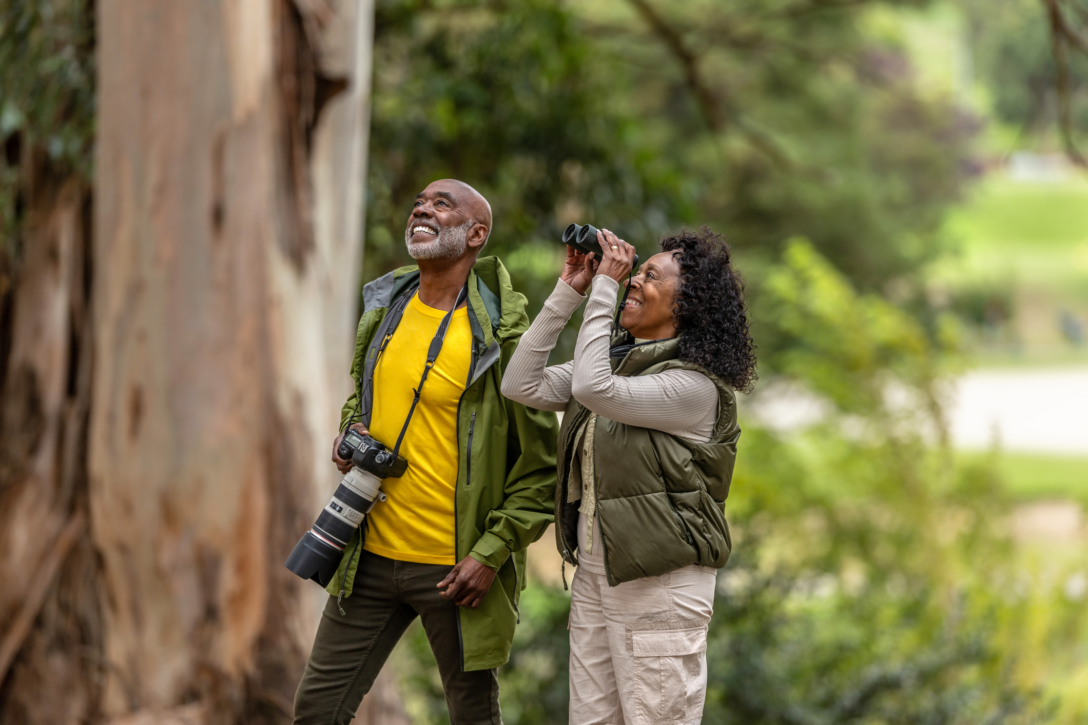 Bird watchers in woods / Getty Plus / JasonDoiy